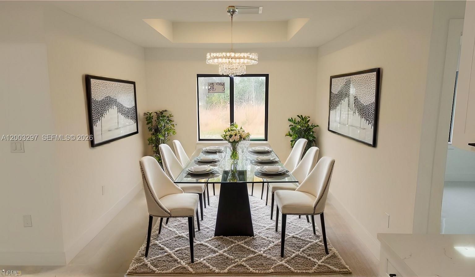 A dining room features a glass-topped table, six white chairs, and a crystal chandelier — 2615 40th ST W, Lehigh Acres FL 33971, LEHIGH ACRES, FL