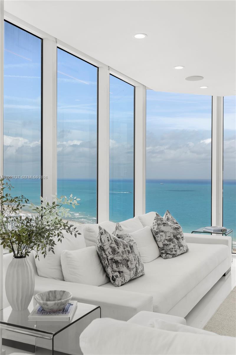 A white sofa sits in a living room with floor-to-ceiling windows overlooking the ocean — 300 S Pointe Dr # 3405, Miami Beach FL 33139, MIAMI BEACH, FL