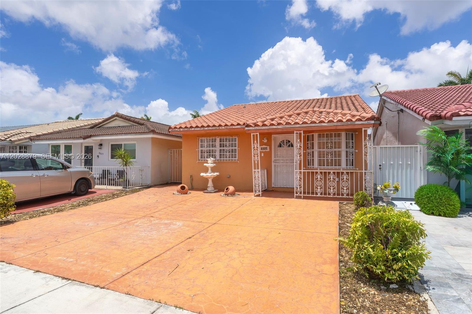 A single-story house with a terracotta tile roof and a stamped concrete driveway — 8805 NW 114th Ter, Hialeah Gardens FL 33018, HIALEAH GARDENS, FL