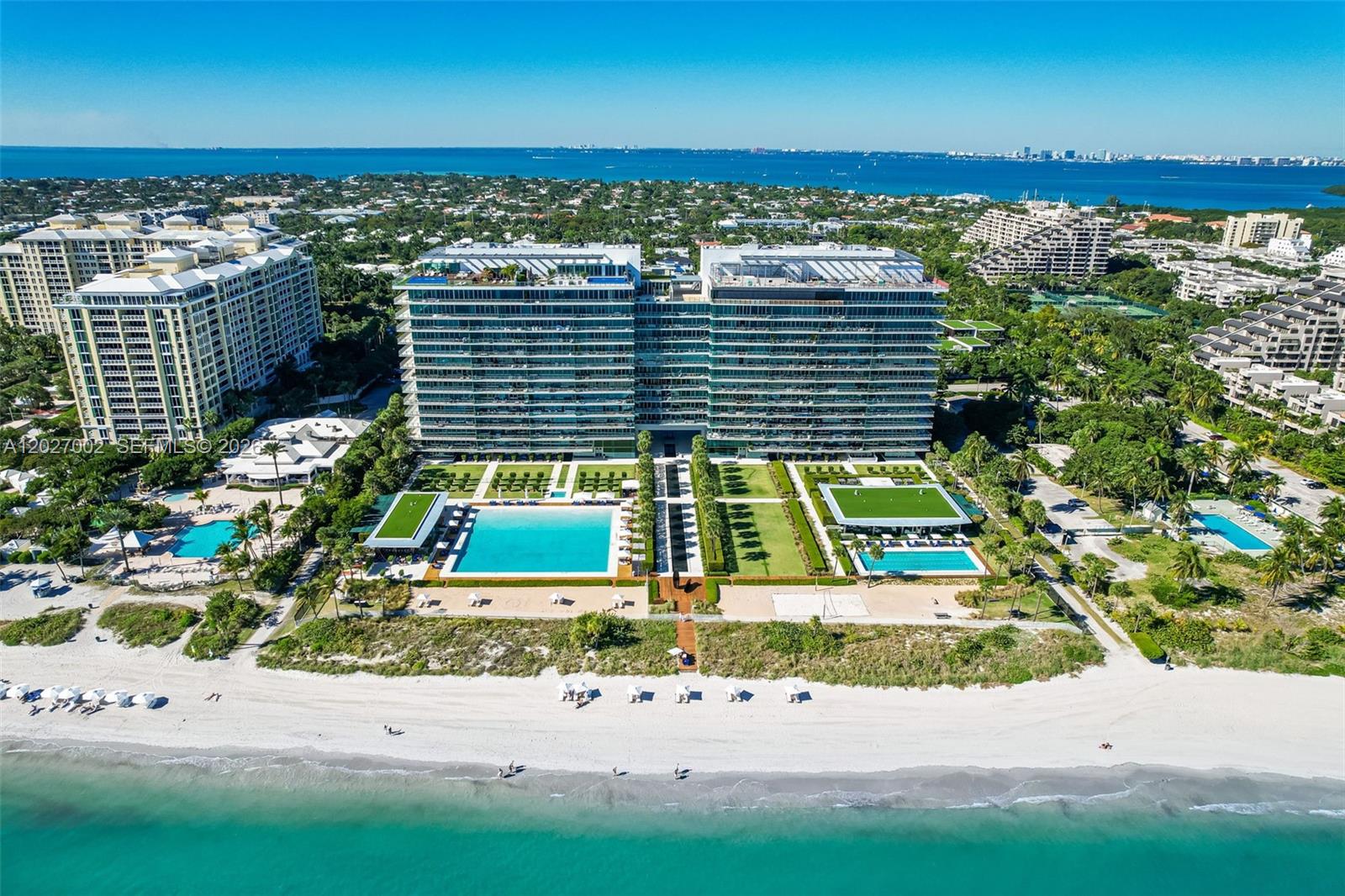 An aerial view shows a large beachfront residential complex with pools and landscaped grounds — 350 Ocean Dr, Key Biscayne FL 33149, KEY BISCAYNE, FL