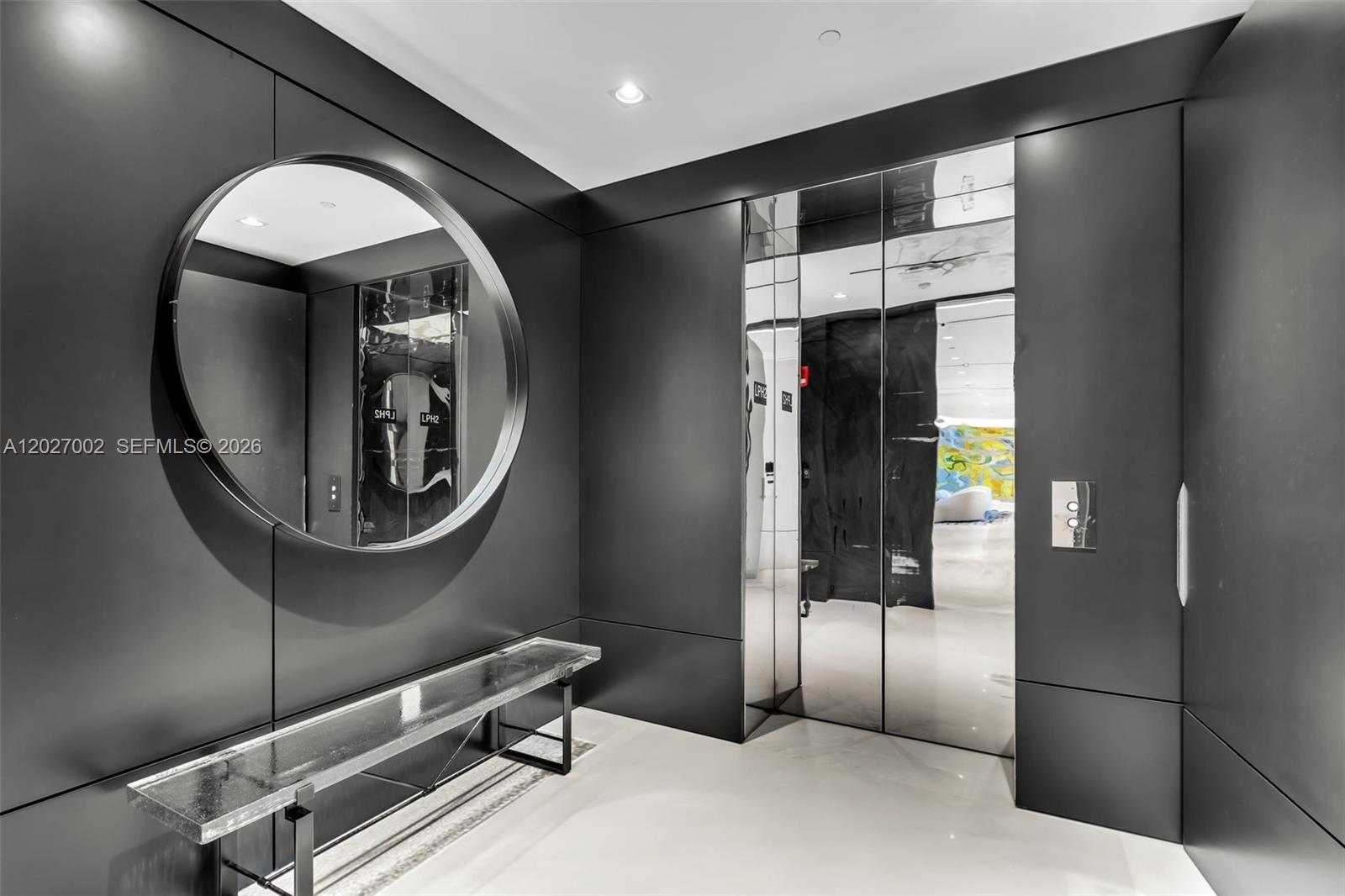 A modern entryway features matte black walls, a circular mirror, a glass bench, and mirrored doors — 350 Ocean Dr, Key Biscayne FL 33149, KEY BISCAYNE, FL