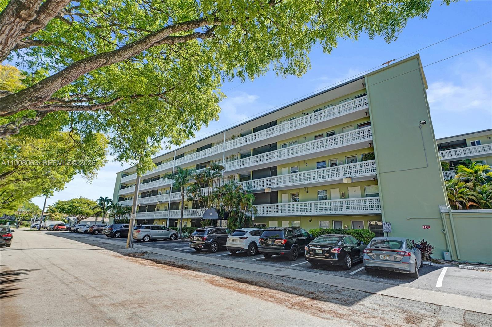 A multi-story apartment building with balconies and a parking lot in front — 1425 Arthur St # 301A, Hollywood FL 33020, HOLLYWOOD, FL