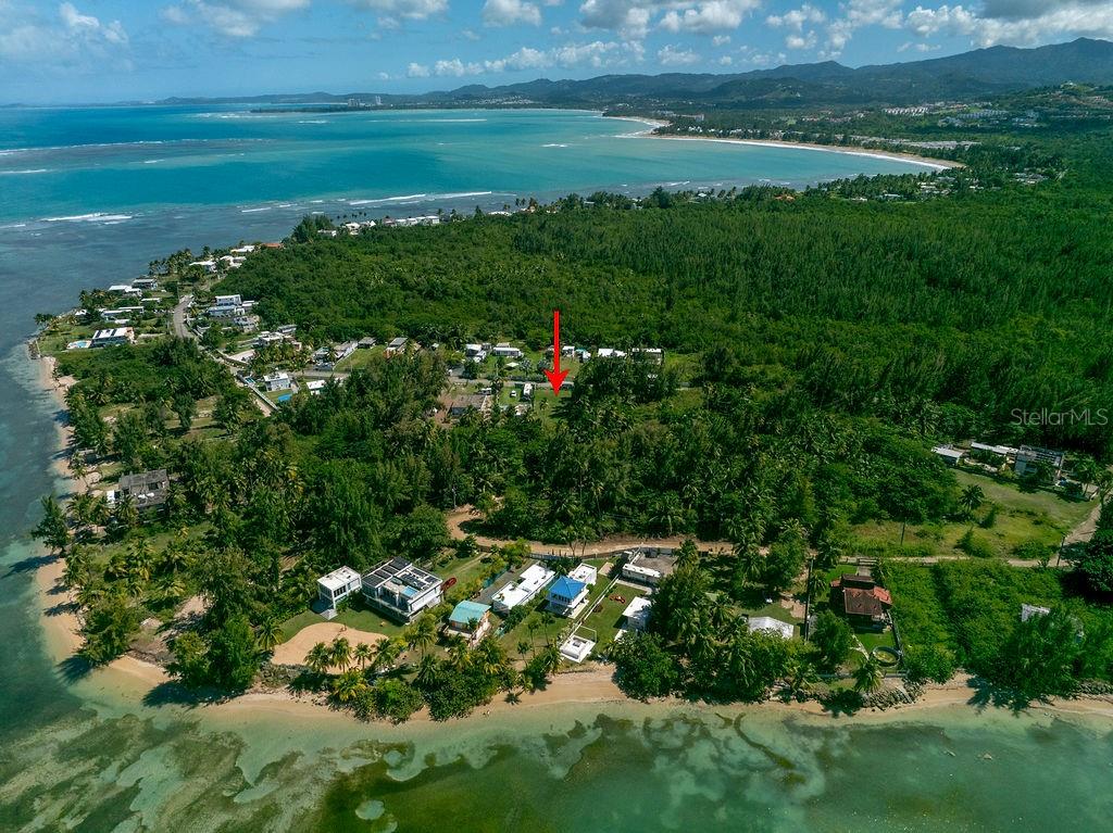 An aerial view shows a coastal area with a red arrow pointing to a property — PR 968 Km. 2.0, LAS PICUA PR 968 KM. 2.0, LOT 18A, PUNTA ARENA, LAS PICUAS UNIT 18A, RIO GRANDE, PR