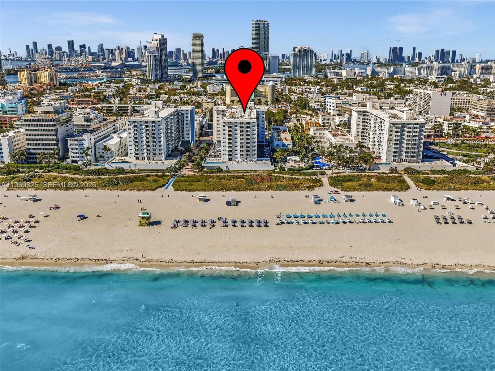 An aerial view shows a beachfront high-rise building marked with a red pin — 401 Ocean Dr # 1007, Miami Beach FL 33139, MIAMI BEACH, FL