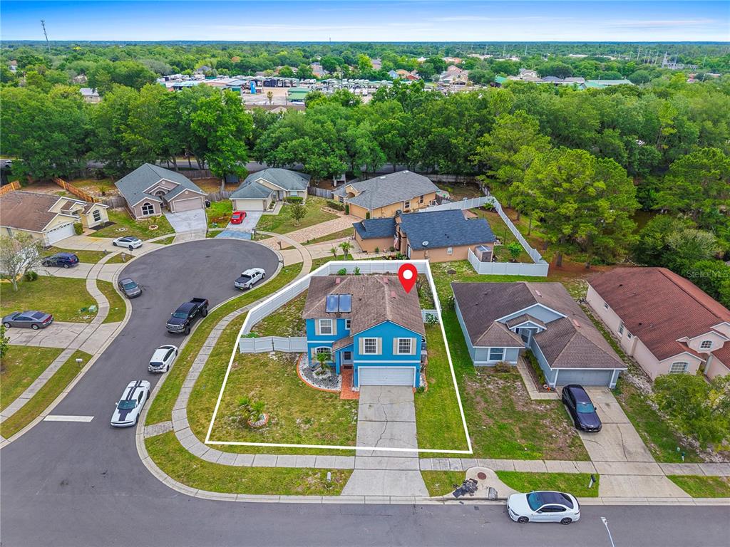 An aerial view shows a two-story blue house with a white fence and driveway — 51 PINE FOREST PLACE, APOPKA, FL