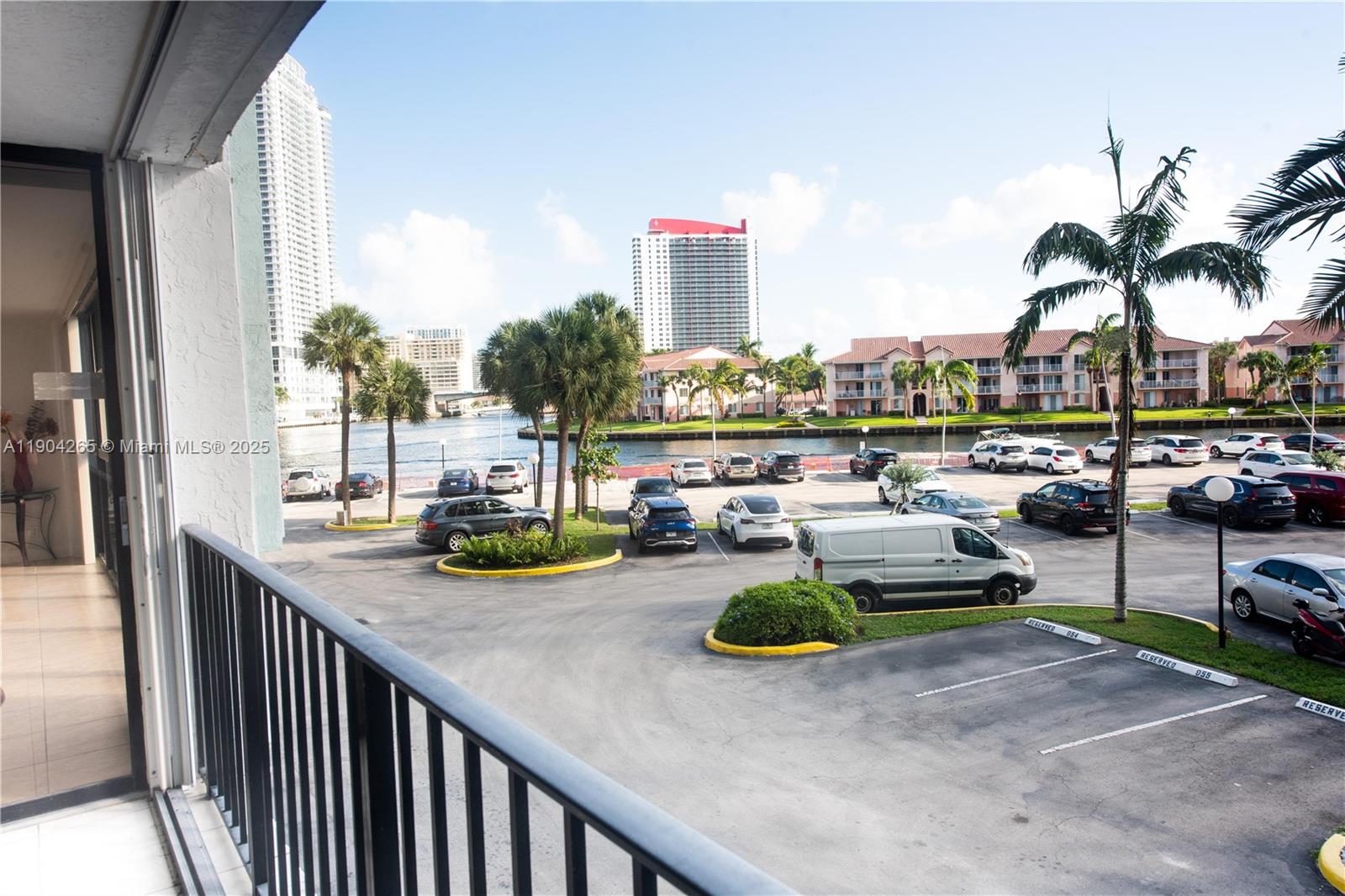 A balcony overlooks a parking lot, a waterway, and several apartment buildings — 200 Leslie Dr # 214, Hallandale Beach FL 33009, HALLANDALE BEACH, FL