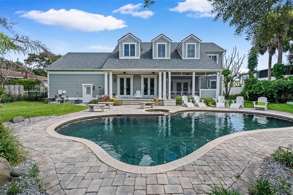 A two-story gray house with a pool, patio, and three dormer windows — 2 HICKORY LANE, DAYTONA BEACH, FL