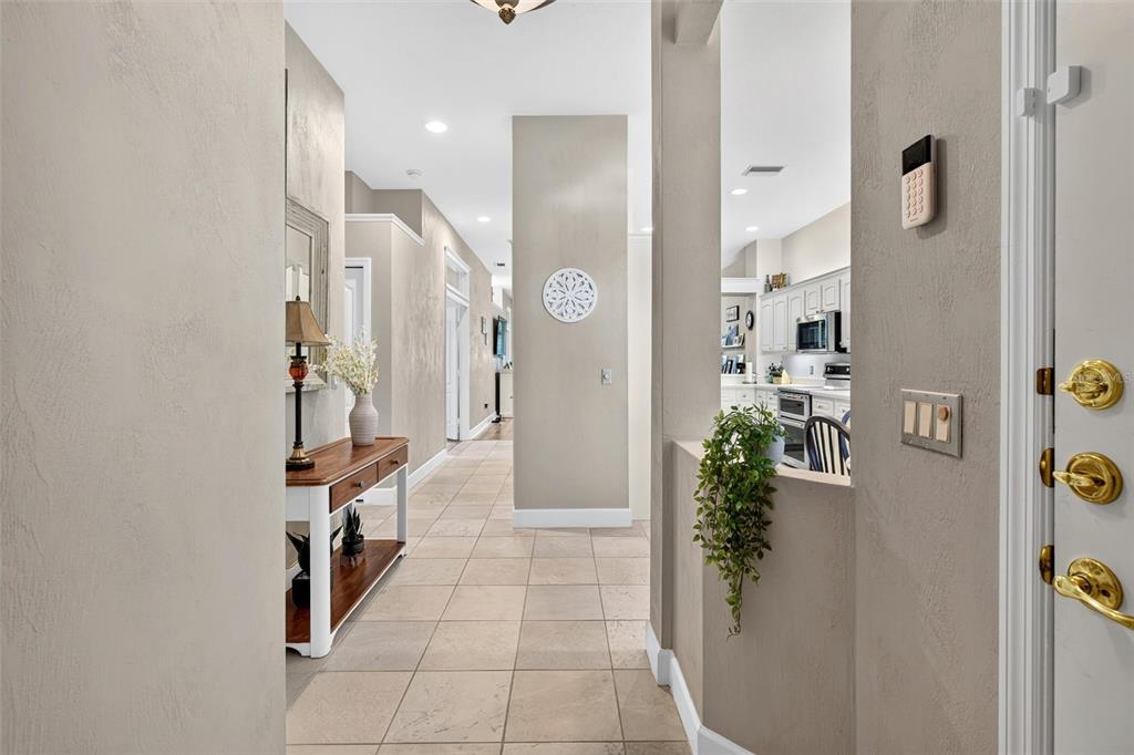 A tiled entryway leads to a hallway and a view into a kitchen — 3167 KAILANI COURT, ORMOND BEACH, FL