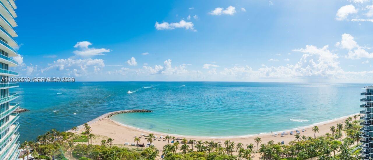 An elevated view of a sandy beach, ocean, and coastal high-rise buildings under a sky — 10295 Collins Ave # 1202, Bal Harbour FL 33154, BAL HARBOUR, FL