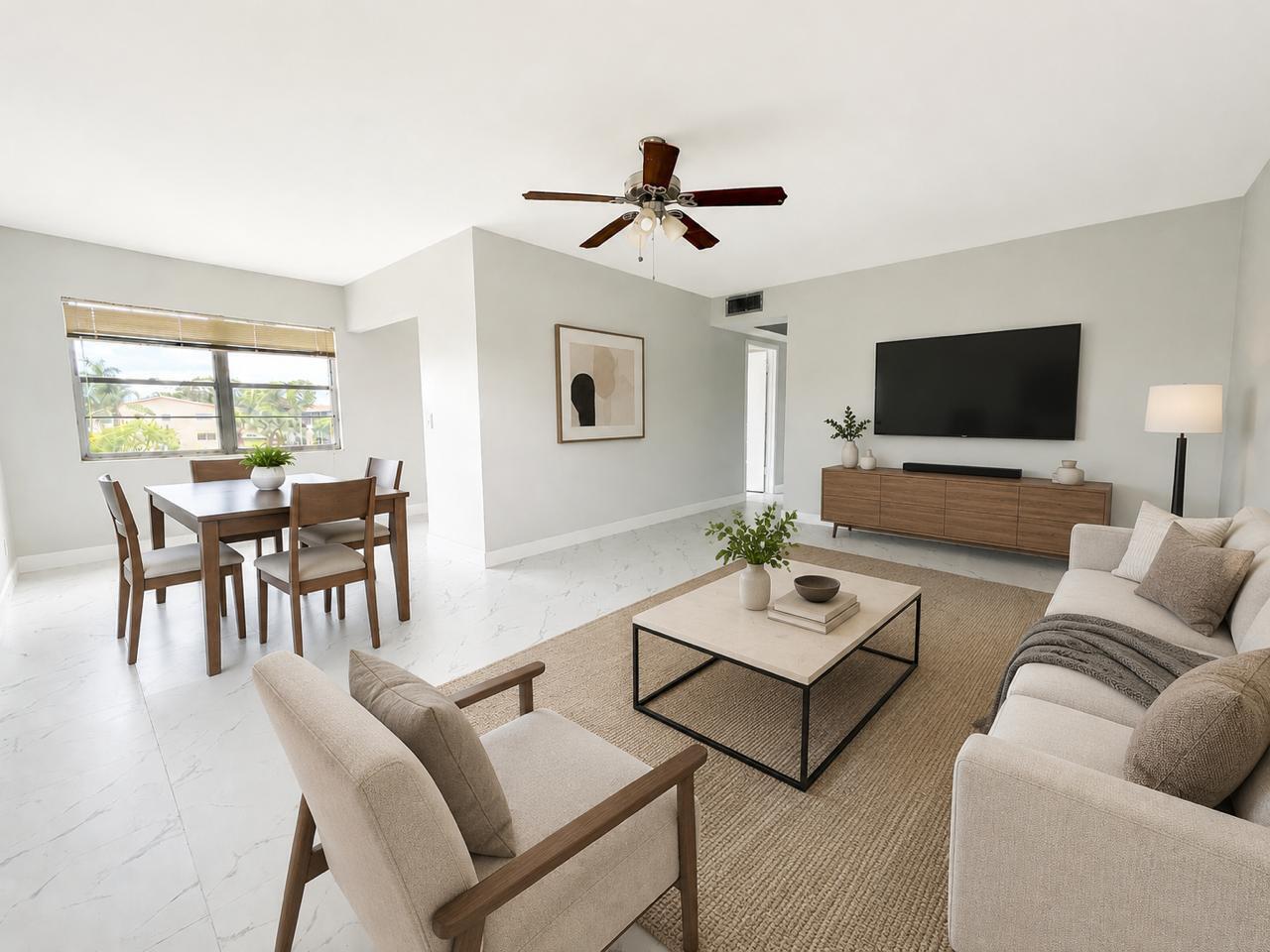 A bright living and dining room features white marble floors, neutral furniture, and a ceiling fan — 365 Brighton I # I, Boca Raton FL 33434, BOCA RATON, FL