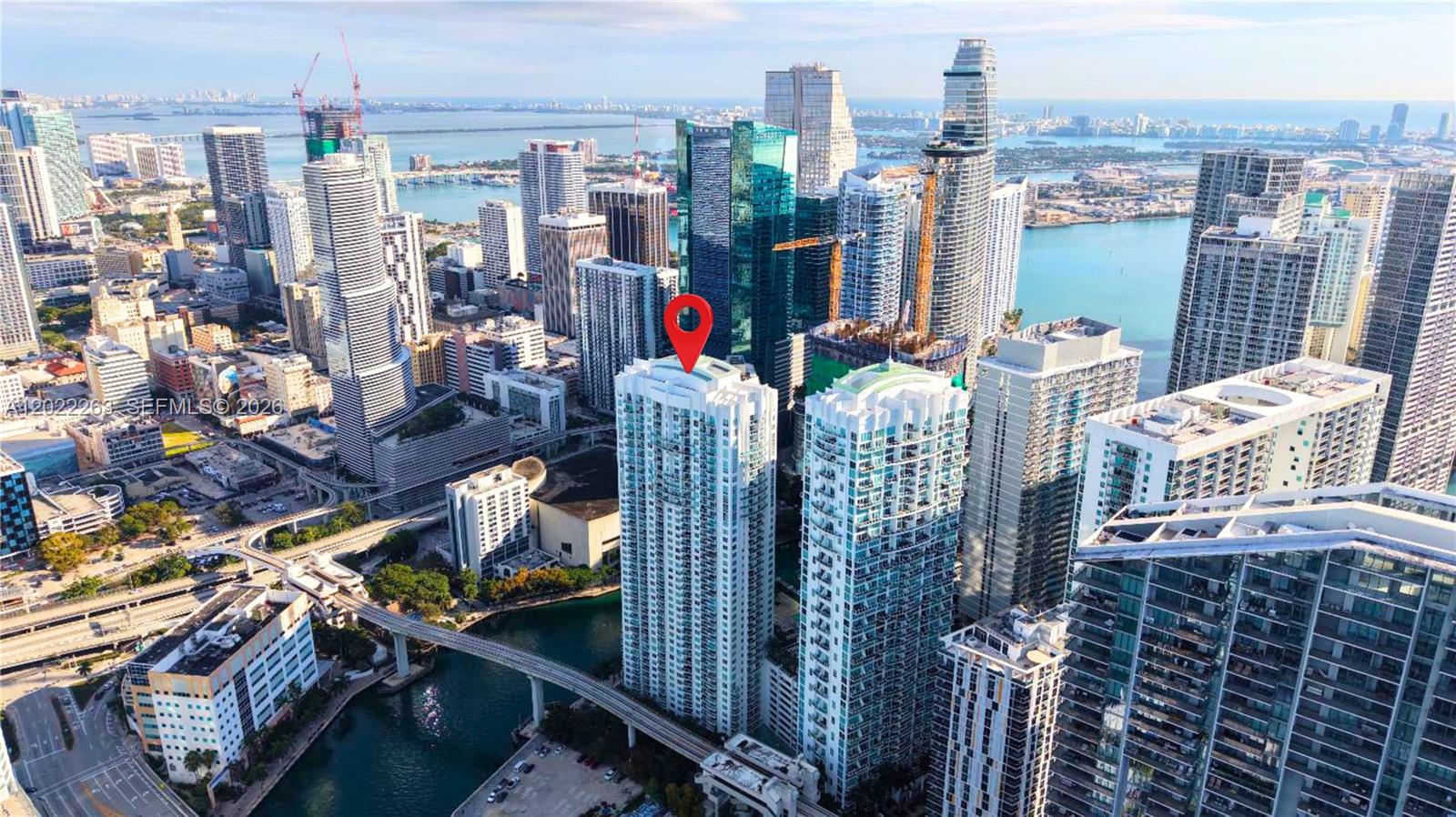 An aerial view of a high-rise building in a dense urban waterfront city — 31 SE 5th St # 203, Miami FL 33131, MIAMI, FL