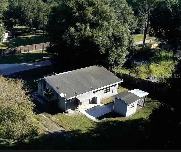 An aerial view of a single-story house with a detached shed and a paved patio — 11829 71ST STREET E, PARRISH, FL