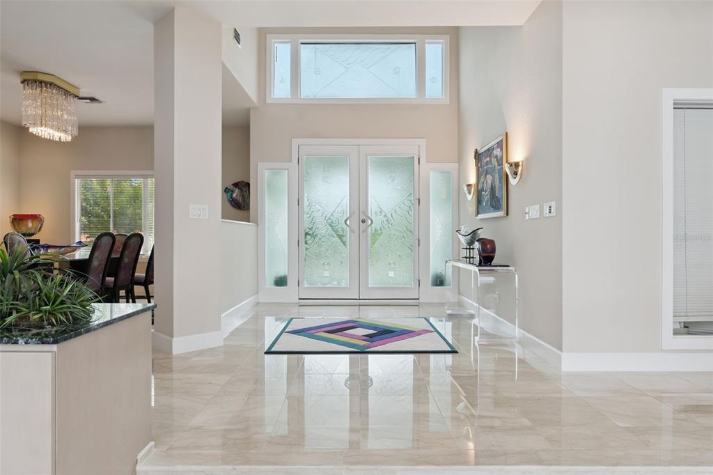 An aerial view shows a waterfront house with a tennis court and a circular driveway — 315 MENASHE COURT, LONGWOOD, FL