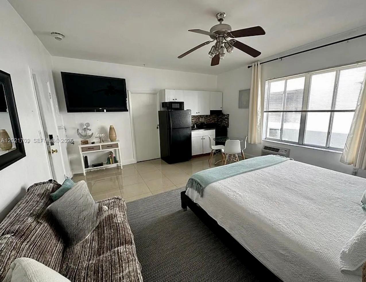This studio apartment features a bed, a small dining area, and a kitchenette — 3700 Collins Ave # 306, Miami Beach FL 33140, MIAMI BEACH, FL