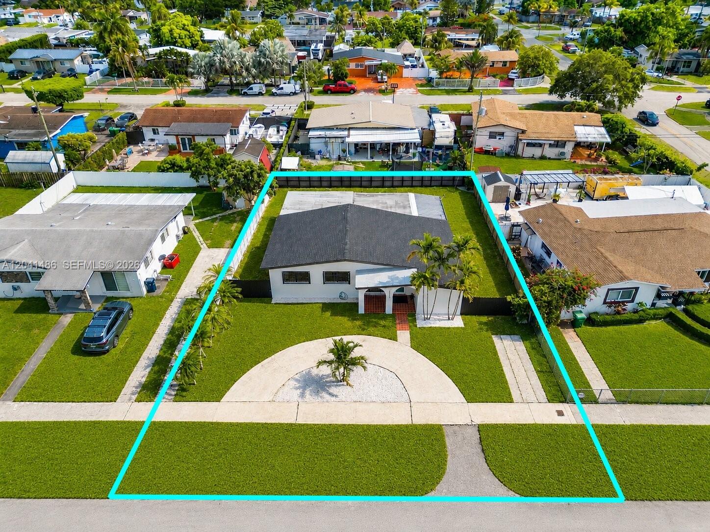 An aerial view shows a single-story house with a circular driveway and fenced backyard — 12370 SW 190th Ter, Miami FL 33177, MIAMI, FL