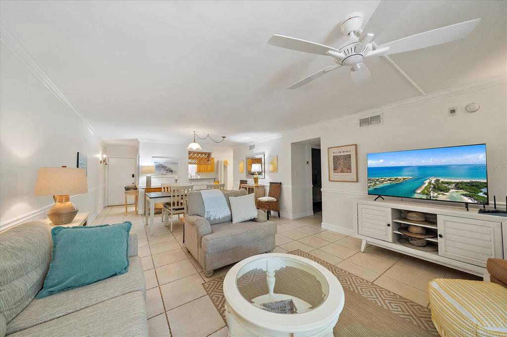 A living room with tile floors, a ceiling fan, and a television on a console — 3360 S OSPREY AVENUE UNIT 104B, SARASOTA, FL