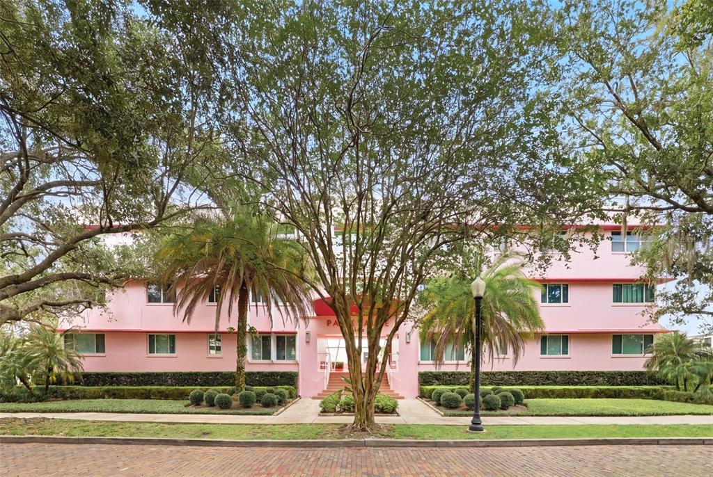 A three-story pink apartment building stands behind a large tree and a brick street — 640 N PARK AVENUE UNIT 5, WINTER PARK, FL