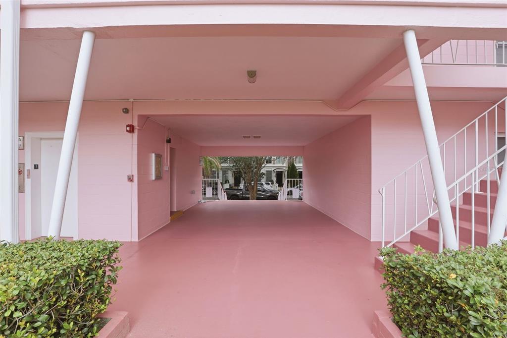 A pink covered parking area features a white staircase and an elevator entrance — 640 N PARK AVENUE UNIT 5, WINTER PARK, FL