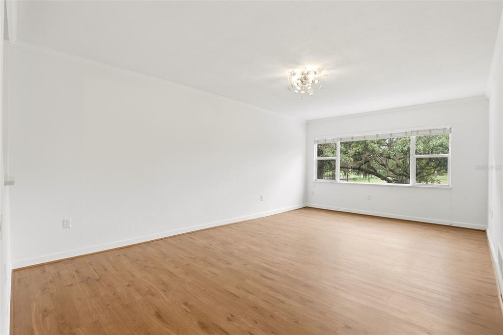An empty room with white walls, light wood-look flooring, and a large window — 640 N PARK AVENUE UNIT 5, WINTER PARK, FL
