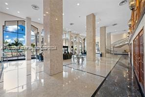 A spacious lobby features polished marble floors, tall stone columns, and large floor-to-ceiling windows — 5601 Collins Ave # 505, Miami Beach FL 33140, MIAMI BEACH, FL
