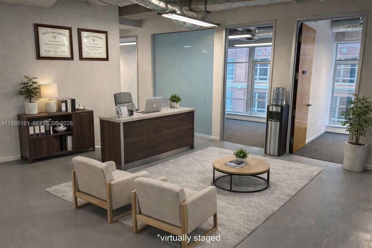 This office space features a desk, two armchairs, a coffee table, and large windows — 14 NE 1st Ave # 500D, Miami FL 33132, MIAMI, FL
