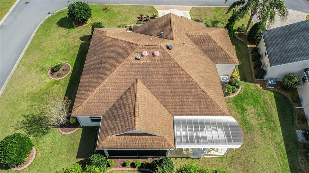 An aerial view of a single-story house with a brown shingled roof and patio — 2946 DUKE TERRACE, THE VILLAGES, FL