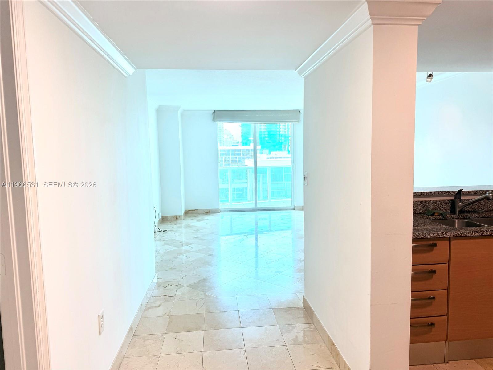 A view through a hallway leads to a living area with tile floors and balcony access — 2101 Brickell Ave # 2202, Miami FL 33129, MIAMI, FL