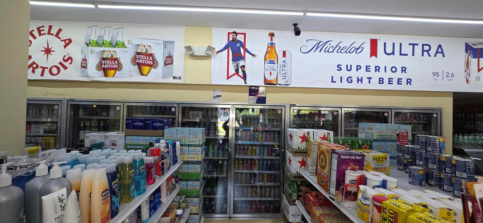 A retail store interior features refrigerated beverage cases topped with large beer brand advertisements — 580 S Federal Highway, Pompano Beach FL 33062, POMPANO BEACH, FL
