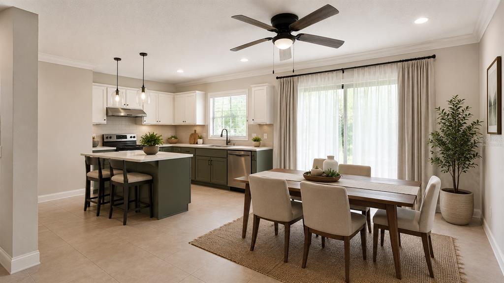A kitchen with a green island and white cabinets sits next to a dining area — 963 MADISON AVENUE AVENUE, DAYTONA BEACH, FL