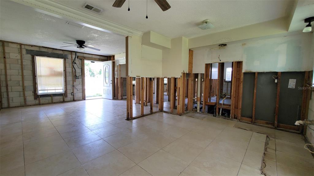 An interior view of a room under renovation with exposed wall studs and tiled flooring — 963 MADISON AVENUE AVENUE, DAYTONA BEACH, FL