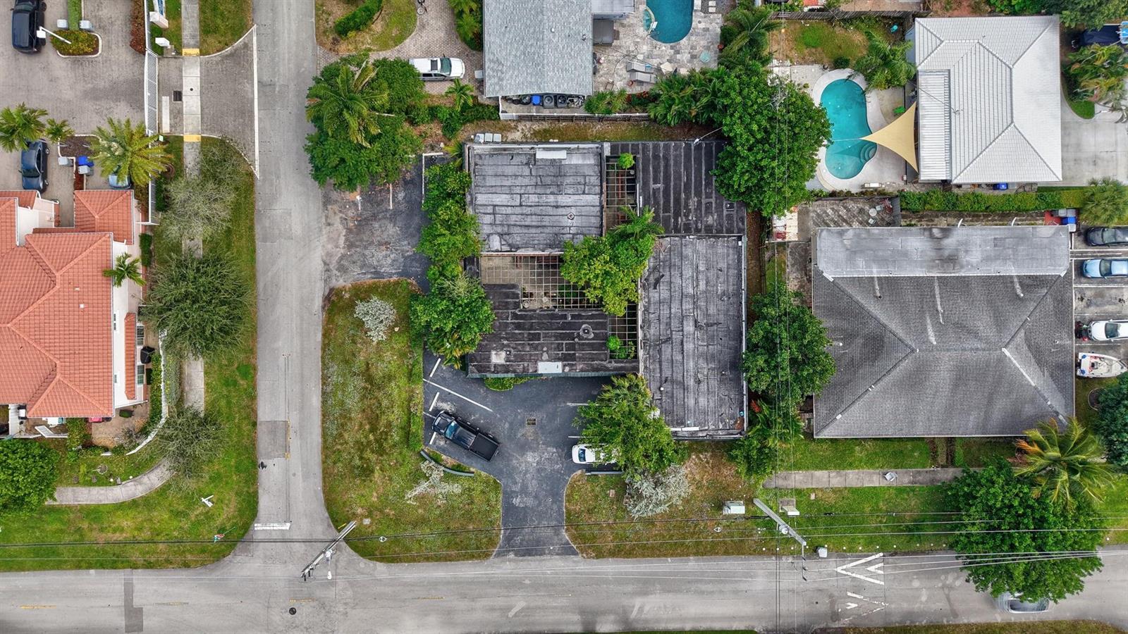 An aerial view shows a flat-roofed commercial building with a parking lot and surrounding properties — 500 SE 23rd Avenue, Pompano Beach FL 33062, POMPANO BEACH, FL