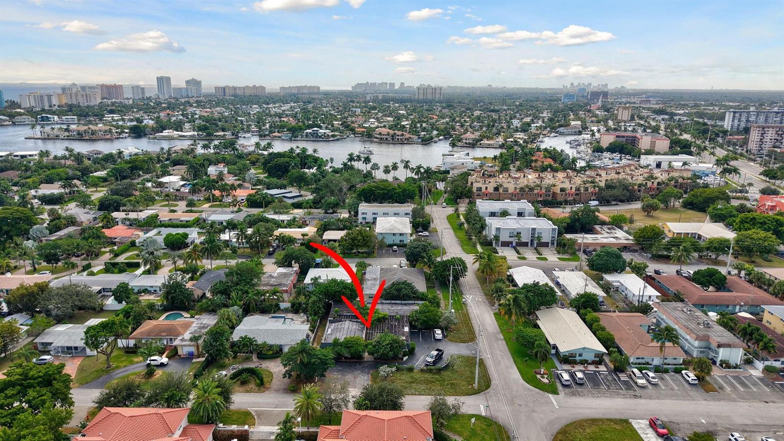An aerial view shows a residential neighborhood with a red arrow pointing to a building — 500 SE 23rd Avenue, Pompano Beach FL 33062, POMPANO BEACH, FL