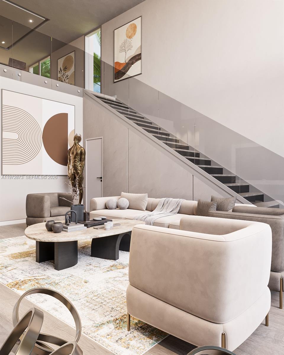 A modern living room features a fireplace, glass-walled staircase, and large windows overlooking a pool — 420 NE 62nd St, Miami FL 33138, MIAMI, FL