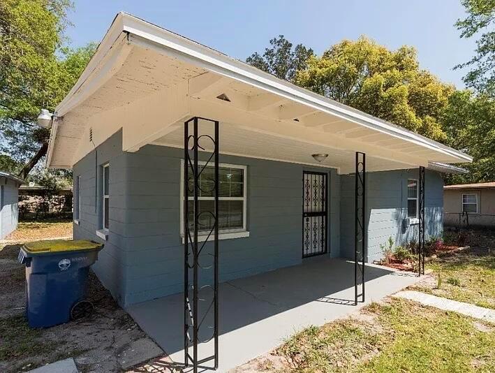 A gray, single-story house with a covered front porch and decorative metal support columns — 2513 Spirea Street, Jacksonville FL 32209, JACKSONVILLE, FL