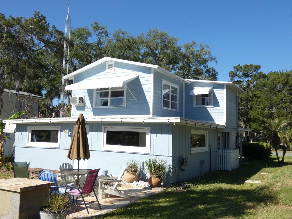 A light blue two-story house with a patio, outdoor furniture, and a tall antenna — 2215 S HUNT POINT, CRYSTAL RIVER, FL