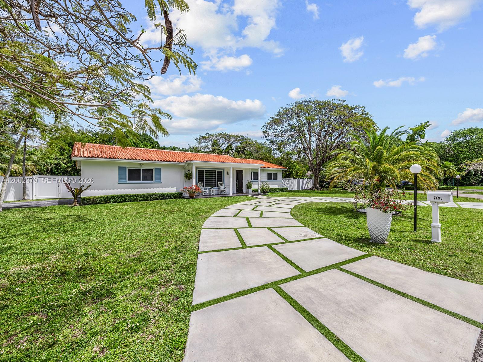 A single-story house with a red tile roof features a modern concrete paver driveway — 7495 SW 73rd Ter, Miami FL 33143, MIAMI, FL