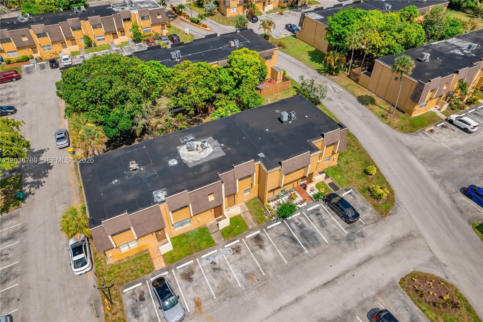 An aerial view shows a multi-unit townhouse building with a flat roof and parking lot — 5653 Blueberry CT # 2, Lauderhill FL 33313, LAUDERHILL, FL