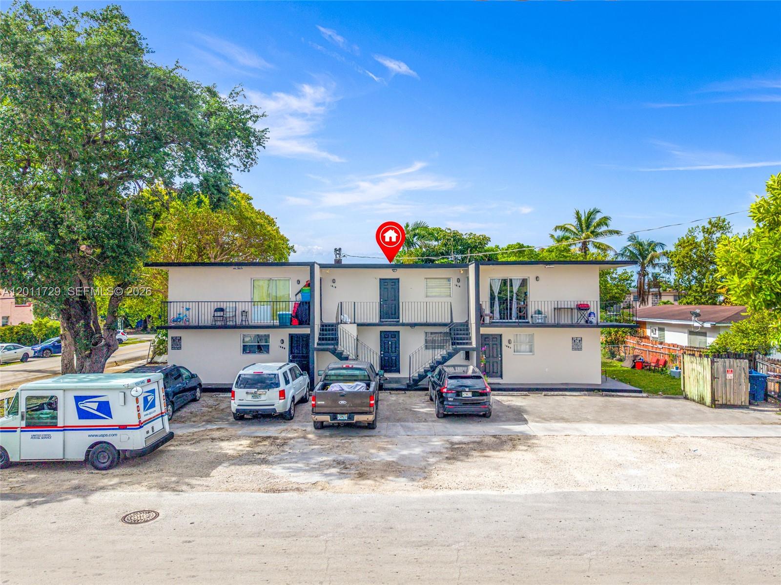 A two-story apartment building with exterior staircases and a parking lot in front — 1800 NW 19th Ter, Miami FL 33125, MIAMI, FL