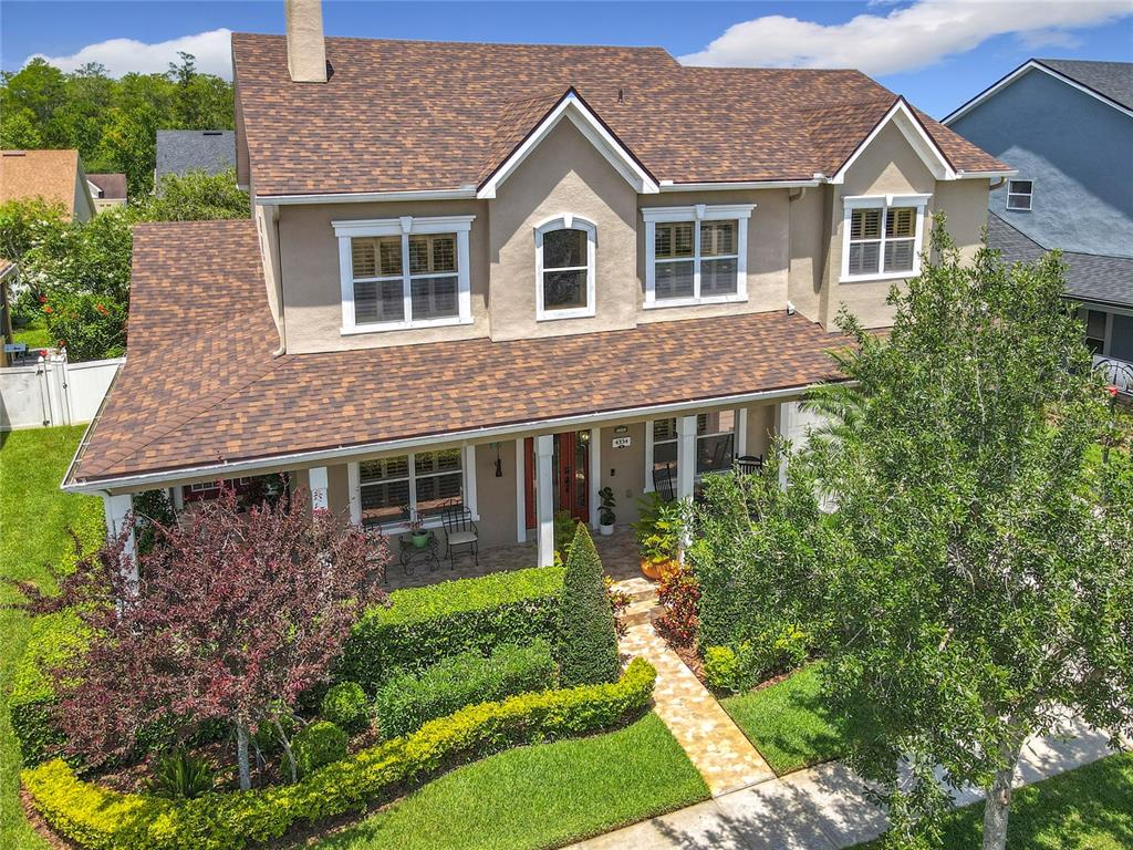 An aerial view of a two-story house with a brown shingled roof and front porch — 4334 TOLKIEN STREET, ORLANDO, FL