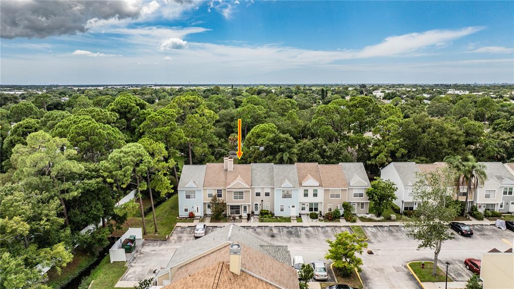 An aerial view shows a row of townhouses with an orange arrow pointing toward one — 6780 121ST AVENUE UNIT 3, LARGO, FL
