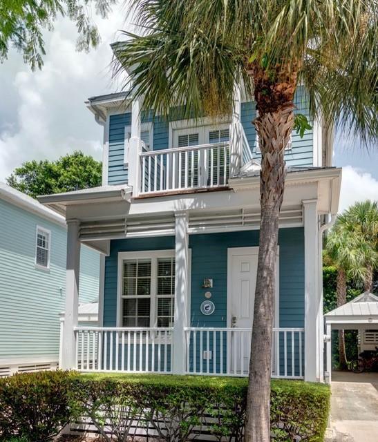 A two-story blue house with a white front porch, balcony, and a palm tree — 102 Anglers Way, Islamorada FL 33036, ISLAMORADA, FL