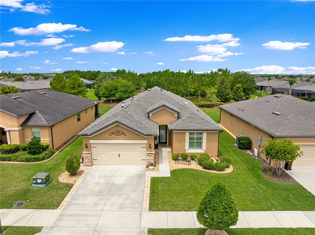 An aerial view of a single-story suburban house with a tan exterior and gray roof — 7762 SW 97TH CIRCLE, OCALA, FL