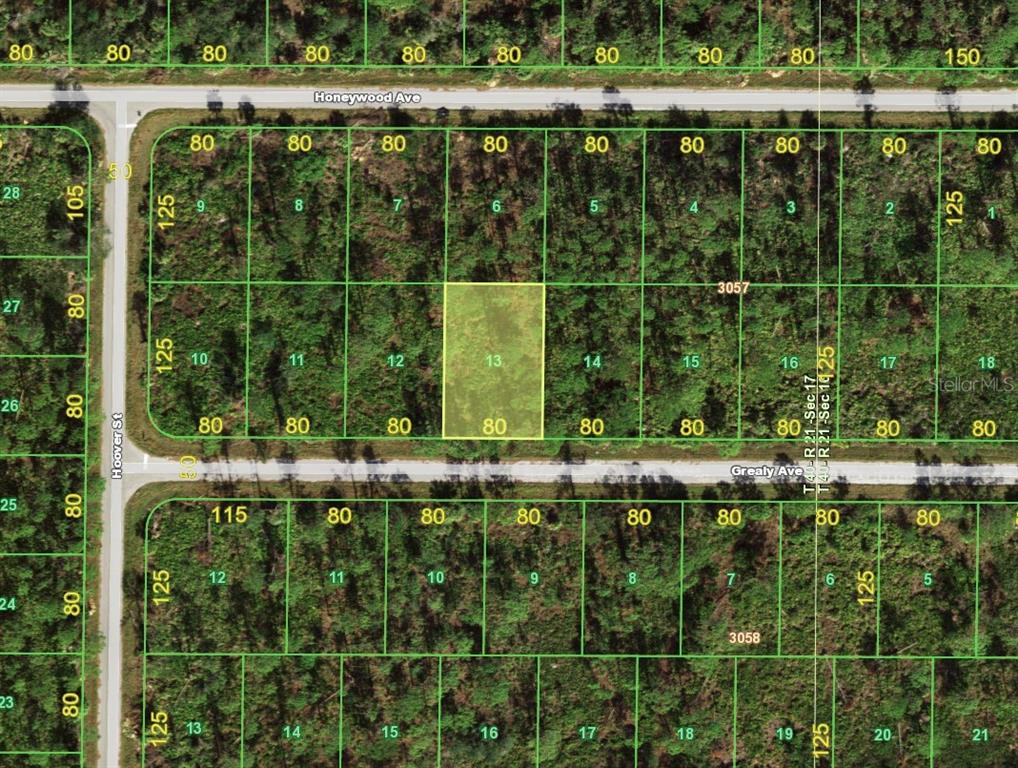 This is a satellite map showing a grid of undeveloped residential lots — 13502 GREALY AVENUE, PORT CHARLOTTE, FL