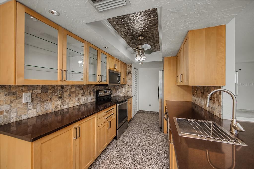A single-story house with a white garage, solar panels on the roof, and a lawn — 2479 ACHILLES STREET, PUNTA GORDA, FL