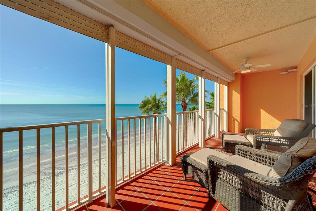 An aerial view of beachfront apartment buildings at sunset with a road in the foreground — 16450 GULF BOULEVARD UNIT 565, NORTH REDINGTON BEACH, FL