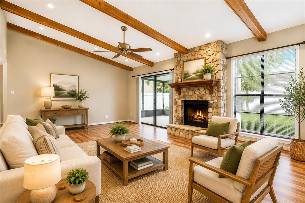 A living room features a stone fireplace, wood ceiling beams, and a light-colored sofa set — 787 EVERT COURT, WINTER SPRINGS, FL