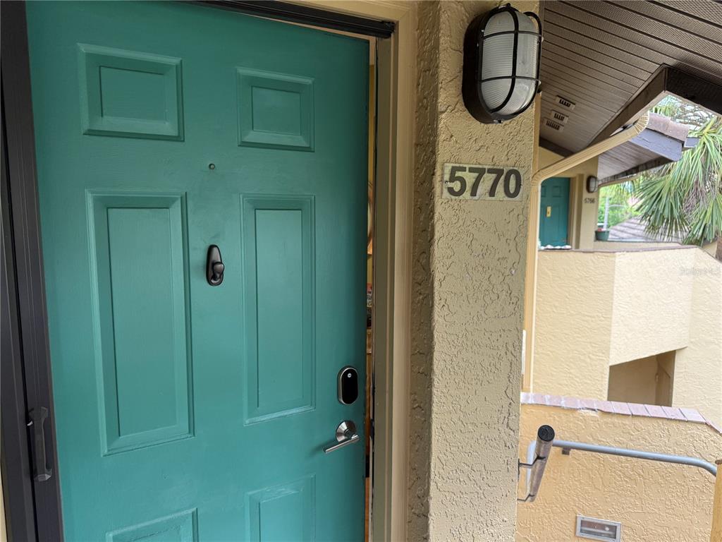 A teal front door with a smart lock and a house number 5770 — 5770 ASHTON LAKE DRIVE UNIT 8, SARASOTA, FL