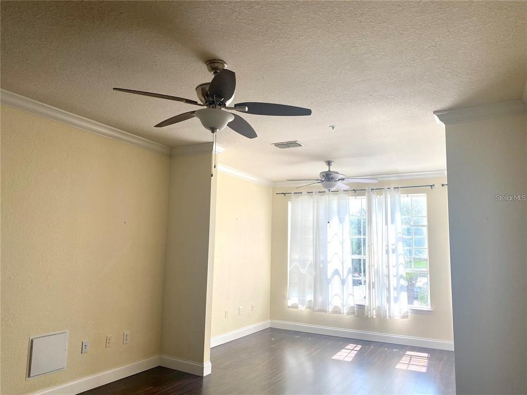 A kitchen with white cabinets and a breakfast bar opens into a dining area — 3325 S KIRKMAN ROAD UNIT 423, ORLANDO, FL