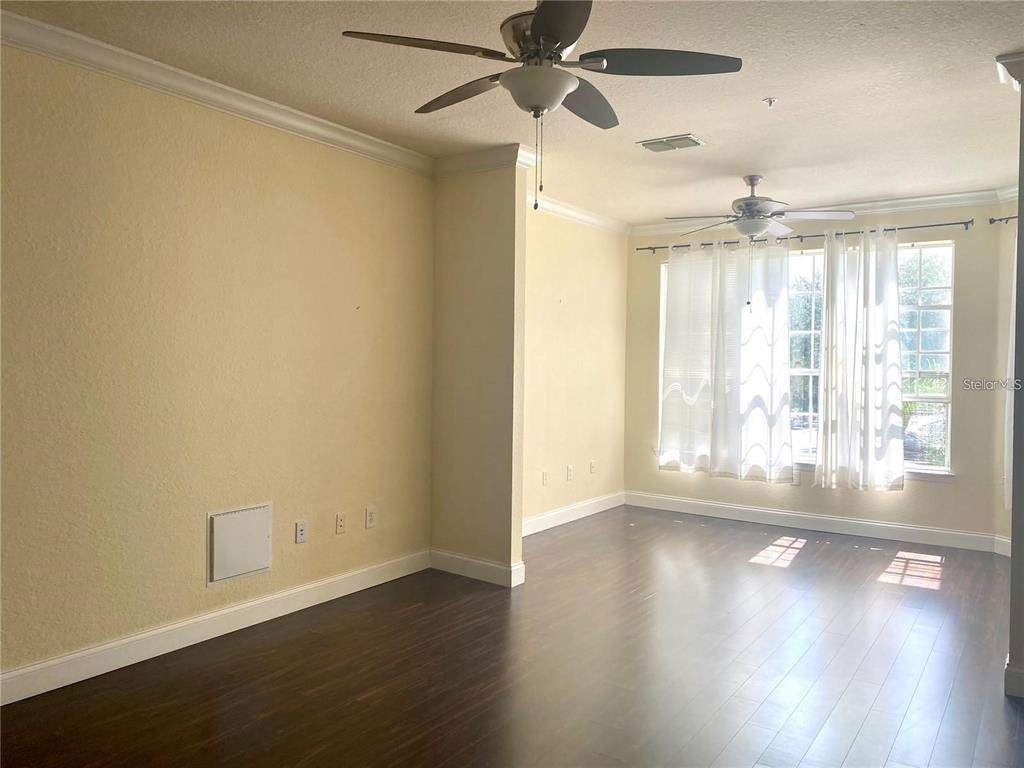A kitchen features white cabinets, a gas stove, a microwave, and a stainless steel sink — 3325 S KIRKMAN ROAD UNIT 423, ORLANDO, FL