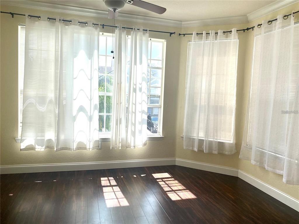 A kitchen with white cabinets and a breakfast bar overlooks a dining area — 3325 S KIRKMAN ROAD UNIT 423, ORLANDO, FL